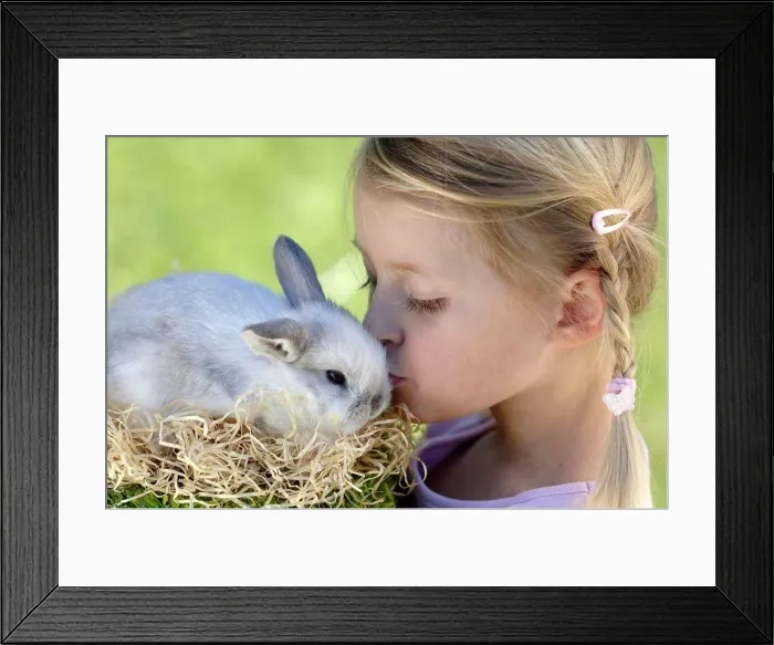 Framed Print : Girl (6-7) kissing Easter bunny, close-up, side view Framed Print : Girl (6-7) kissing Easter bunny, close-up, side view