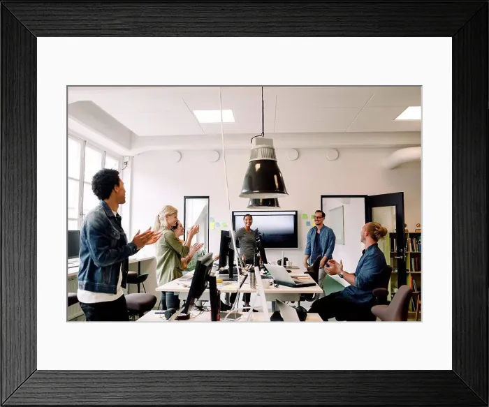 Framed Print : Business colleagues clapping for smiling speakers in office meeting Framed Print : Business colleagues clapping for smiling speakers in office meeting