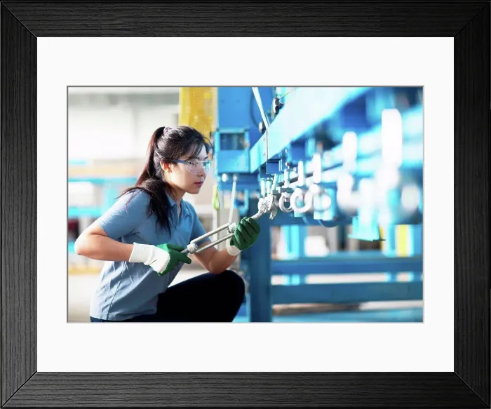 Framed Print : Technician operating machine in factory Framed Print : Technician operating machine in factory