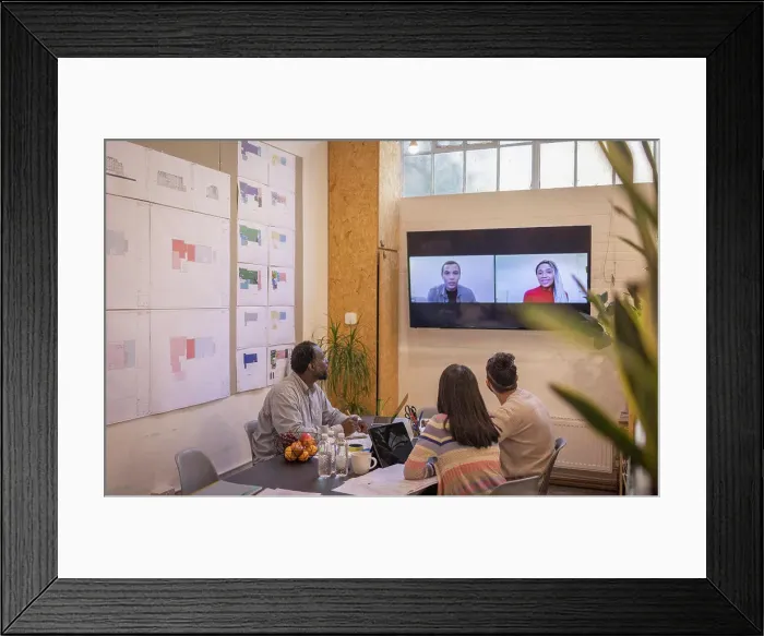 Framed Print : Business people video conferencing with colleagues in meeting Framed Print : Business people video conferencing with colleagues in meeting