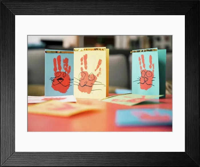 Framed Print : Self-made Easter bunny cards with handprints on a table