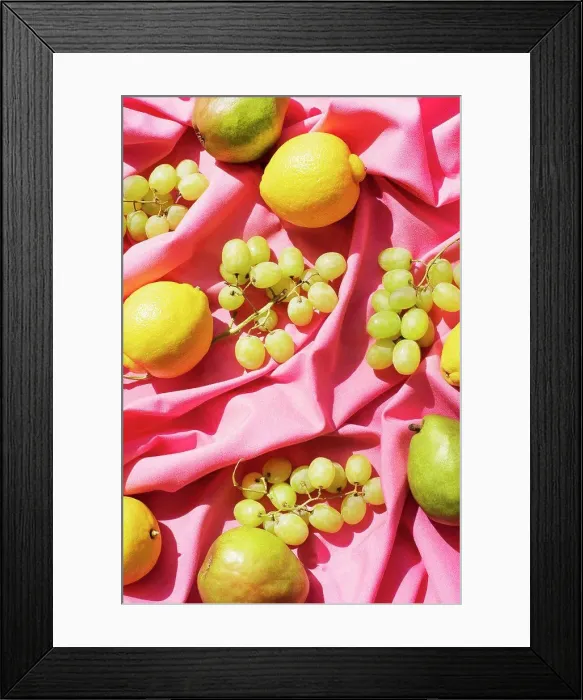 Framed Print : Overhead view of lemons, pears and grapes on pink table cloth Framed Print : Overhead view of lemons, pears and grapes on pink table cloth