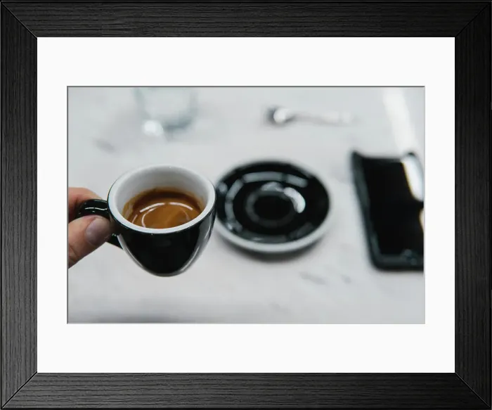 Framed Print : cup of coffee in a hand cup of coffee in a hand on a light background Framed Print : cup of coffee in a hand cup of coffee in a hand on a light background