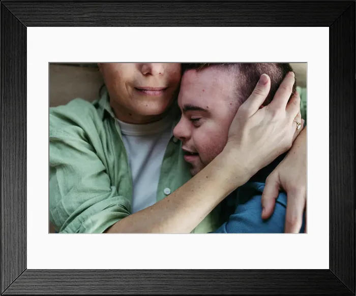 Framed Print : Portrait of young man with Down syndrome with his mother at home