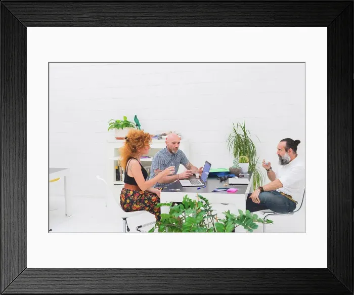 Framed Print : Businessmen and woman having discussion at office meeting Framed Print : Businessmen and woman having discussion at office meeting
