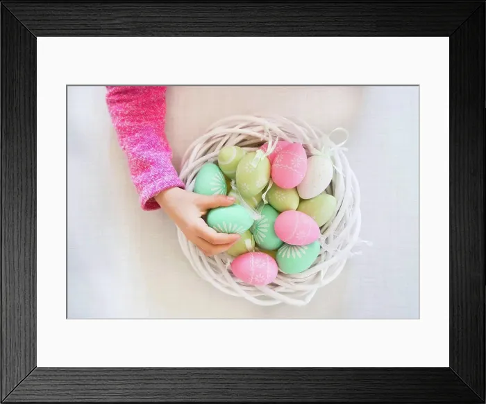 Framed Print : Girl's hand taking coloured Easter egg Framed Print : Girl's hand taking coloured Easter egg