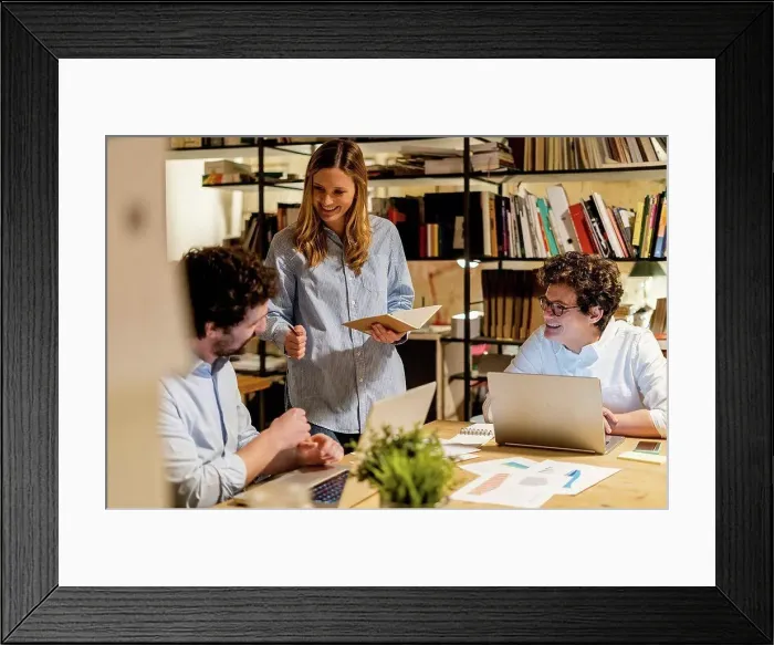 Framed Print : Coworkers working at desk in office Framed Print : Coworkers working at desk in office
