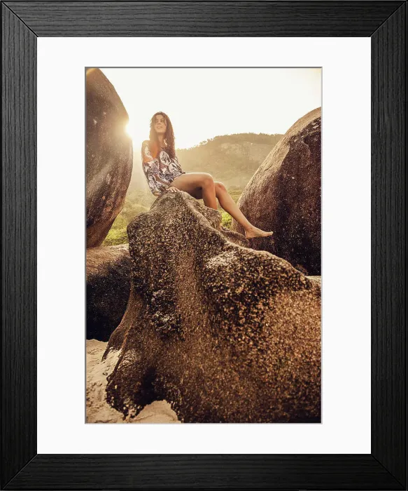 Framed Print : Hispanic woman sitting on boulder
