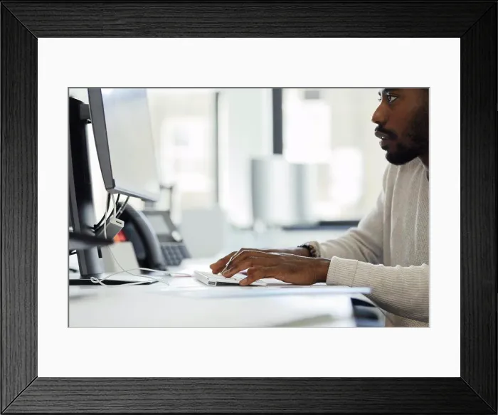 Framed Print : Businessman working at computer at office desk Framed Print : Businessman working at computer at office desk