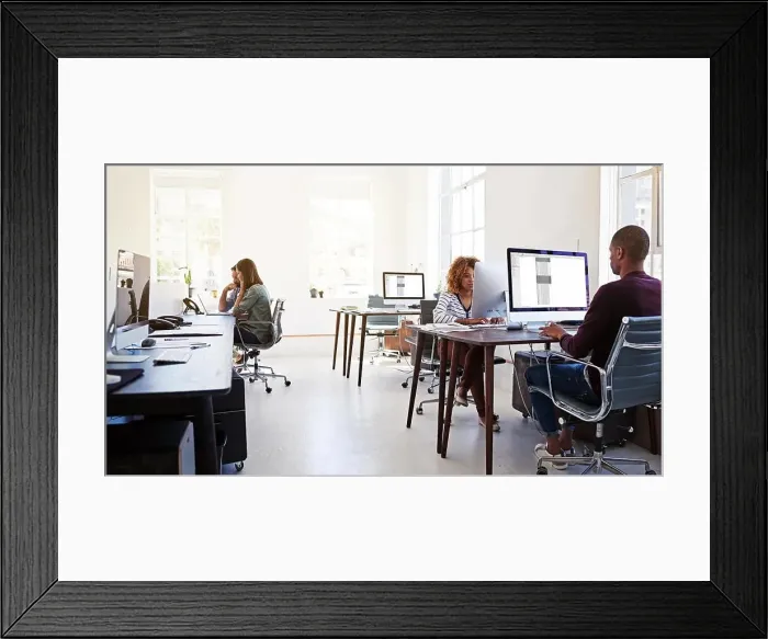 Framed Print : Working in an open plan office. Shot of colleagues working on their computers in an open plan office Framed Print : Working in an open plan office. Shot of colleagues working on their computers in an open plan office