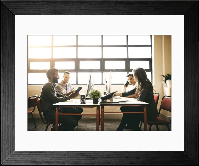 Framed Print : Just another day in the office. designers working in a modern office