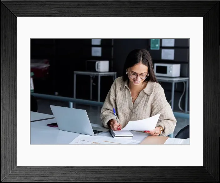 Framed Print : Smiling businesswoman working at office Framed Print : Smiling businesswoman working at office