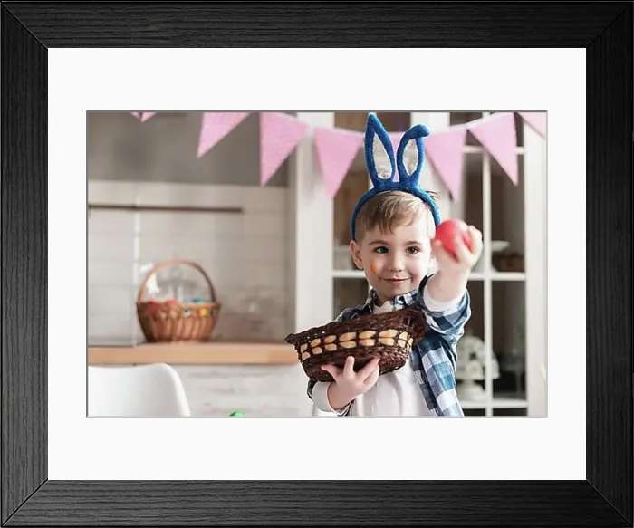 Framed Print : Portrait cute young boy holding easter egg Framed Print : Portrait cute young boy holding easter egg