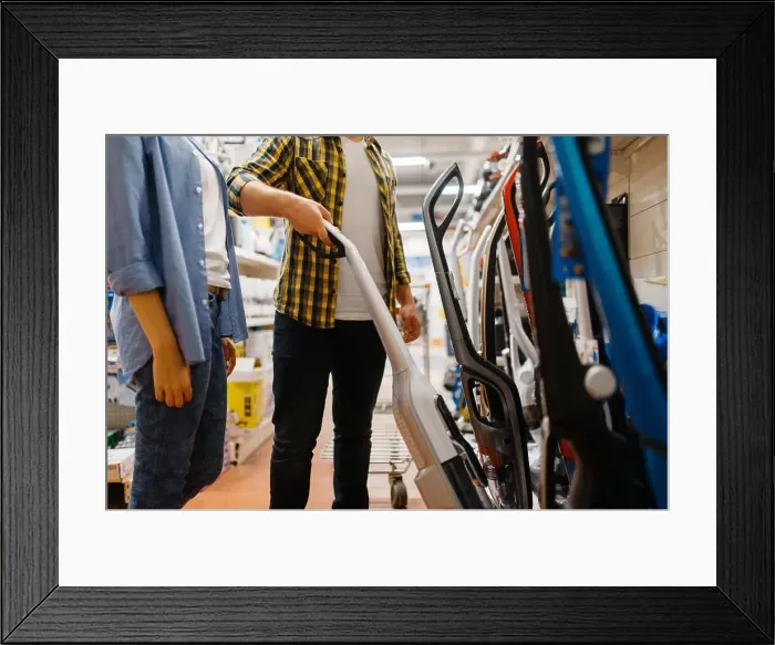 Framed Print : Male person hand holds vacuum cleaner in electronics store Framed Print : Male person hand holds vacuum cleaner in electronics store