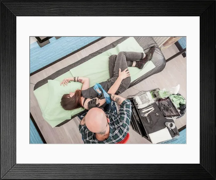 Framed Print : Tattooist drawing on arm of client Framed Print : Tattooist drawing on arm of client