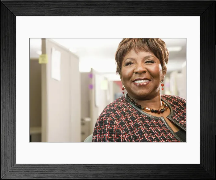 Framed Print : Smiling Black businesswoman standing in office Framed Print : Smiling Black businesswoman standing in office