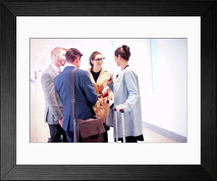 Framed Print : Businessmen and women chatting in airport Framed Print : Businessmen and women chatting in airport