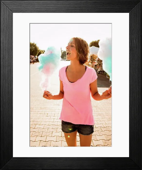 Framed Print : Woman eating cotton candy outdoors Framed Print : Woman eating cotton candy outdoors