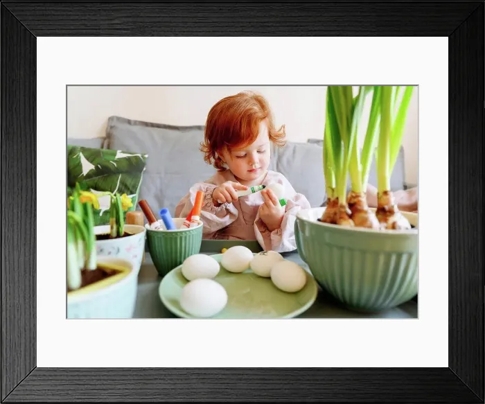 Framed Print : Girl coloring egg during Easter at home