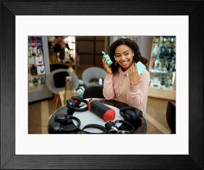 Framed Print : Customer buying headphones in audio store Framed Print : Customer buying headphones in audio store