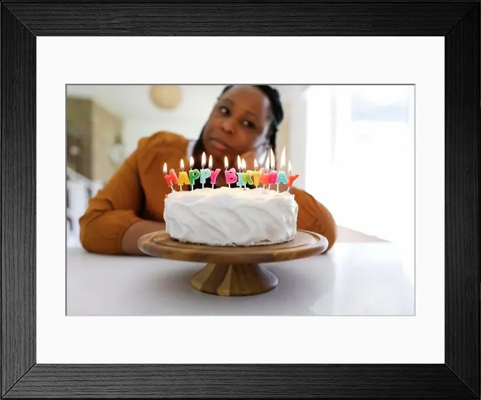 Framed Print : Portrait of woman behind birthday cake Framed Print : Portrait of woman behind birthday cake