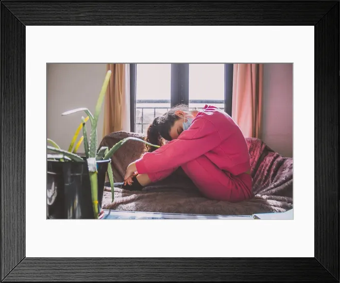 Framed Print : young woman with protective mask on the sofa Framed Print : young woman with protective mask on the sofa