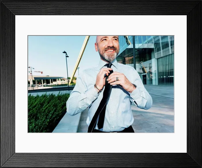 Framed Print : Mature businessman outdoors, straightening his tie Framed Print : Mature businessman outdoors, straightening his tie