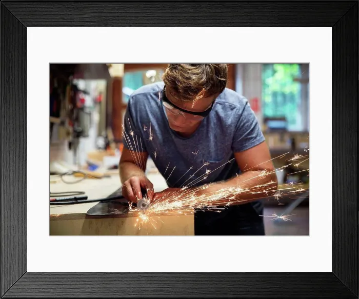 Framed Print : Man in workshop, making ski equipment, using hand tools on metal Framed Print : Man in workshop, making ski equipment, using hand tools on metal