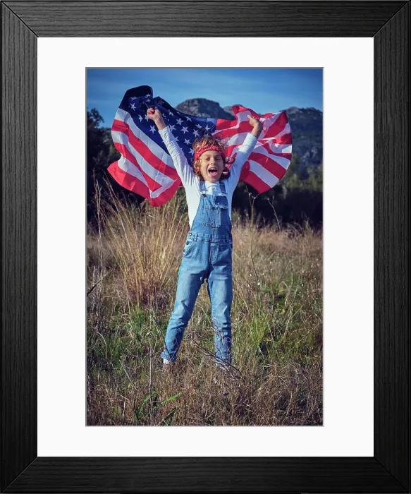 Framed Print : Boy in nature holding an American flag Framed Print : Boy in nature holding an American flag