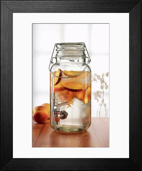 Framed Print : Glass jar with tap dispenser containing fresh peach drink Framed Print : Glass jar with tap dispenser containing fresh peach drink