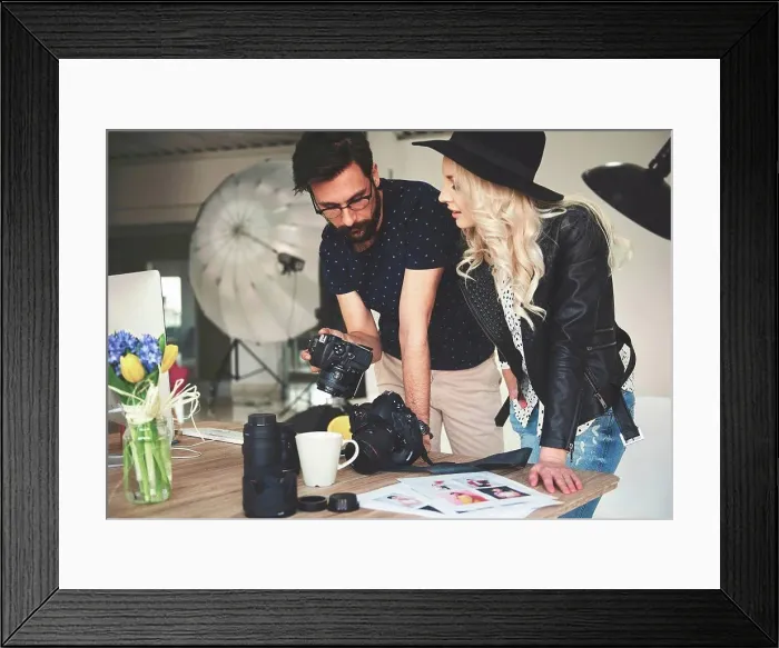Framed Print : Photographer and stylist reviewing photographs on photography studio camera Framed Print : Photographer and stylist reviewing photographs on photography studio camera