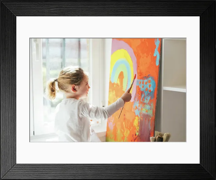 Framed Print : Creative blond girl in casual clothes sitting on window sill against window Framed Print : Creative blond girl in casual clothes sitting on window sill against window