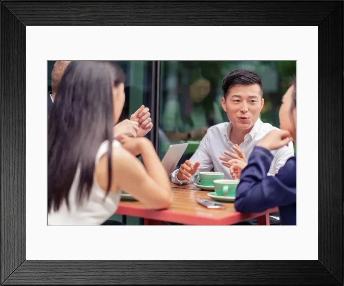 Framed Print : Group of businesspeople, having meeting at cafe, outdoors Framed Print : Group of businesspeople, having meeting at cafe, outdoors