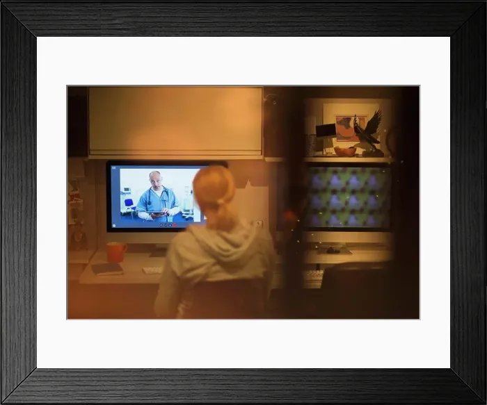 Framed Print : Woman video conferencing with doctor on computer screen