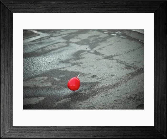 Framed Print : Red ball flies over asphalt. Balloon outside Framed Print : Red ball flies over asphalt. Balloon outside