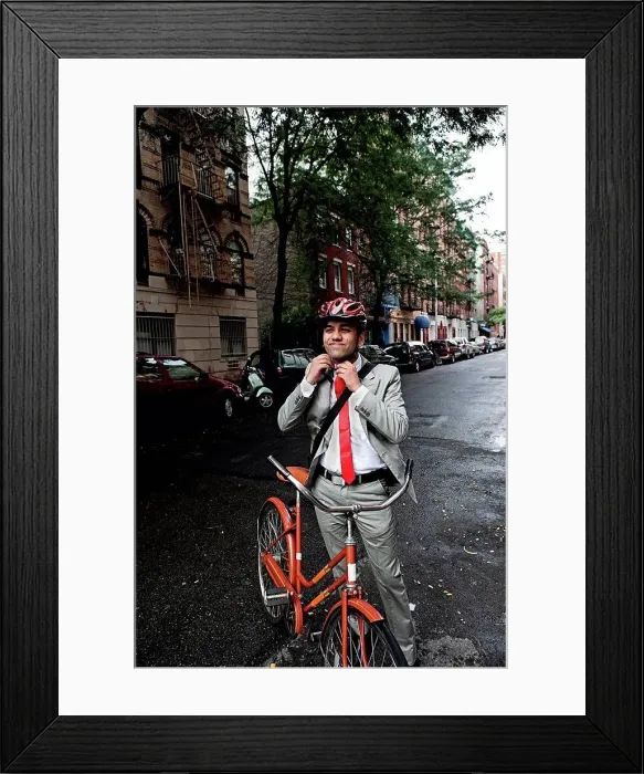 Framed Print : Young businessman adjusting cycle helmet in street Framed Print : Young businessman adjusting cycle helmet in street
