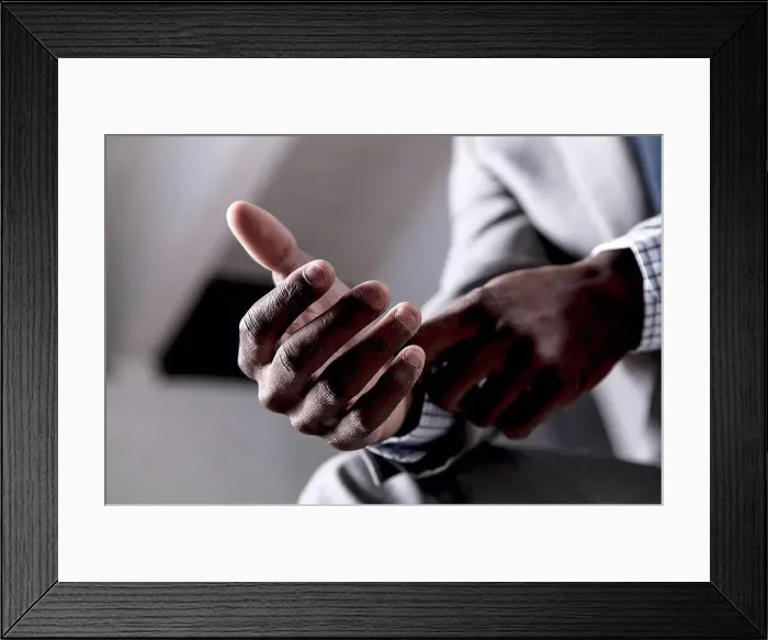 Framed Print : Young man buttoning shirt cuff, close-up Framed Print : Young man buttoning shirt cuff, close-up