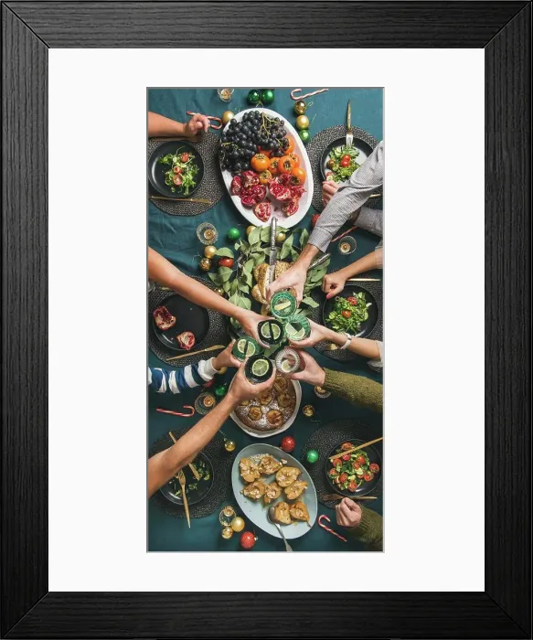 Framed Print : Company of friends gathering for Christmas or New Year party dinner at festive table Framed Print : Company of friends gathering for Christmas or New Year party dinner at festive table