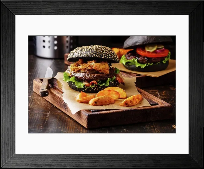 Framed Print : Black burger with sesame seed bun, meat, bacon, onion fries rings and potato wedges on dark wooden background Framed Print : Black burger with sesame seed bun, meat, bacon, onion fries rings and potato wedges on dark wooden background