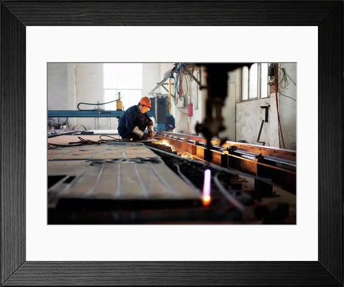 Framed Print : Worker using equipment in crane manufacturing facility, China Framed Print : Worker using equipment in crane manufacturing facility, China
