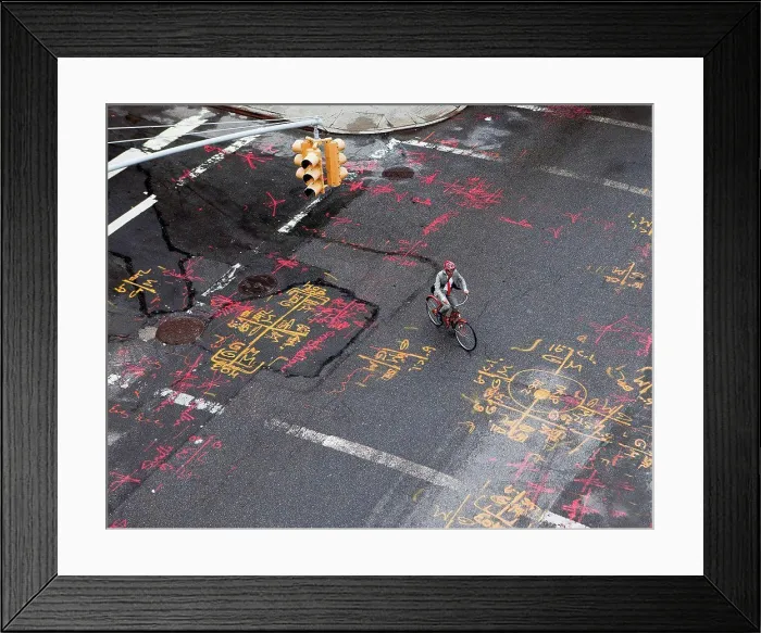 Framed Print : Businessman cycling along city road, high angle view Framed Print : Businessman cycling along city road, high angle view