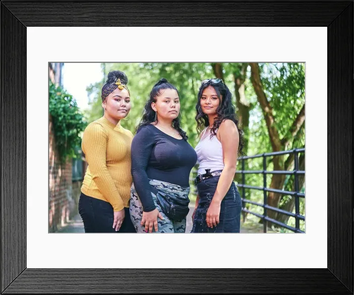 Framed Print : Young woman posing with teenage sisters by park, portrait Framed Print : Young woman posing with teenage sisters by park, portrait