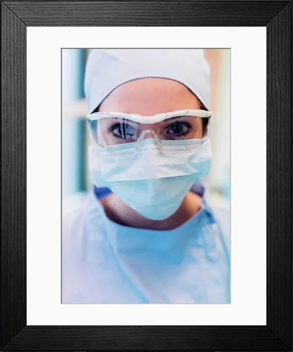 Framed Print : Portrait of female dentist, wearing surgical mask and protective eyewear, close-up Framed Print : Portrait of female dentist, wearing surgical mask and protective eyewear, close-up