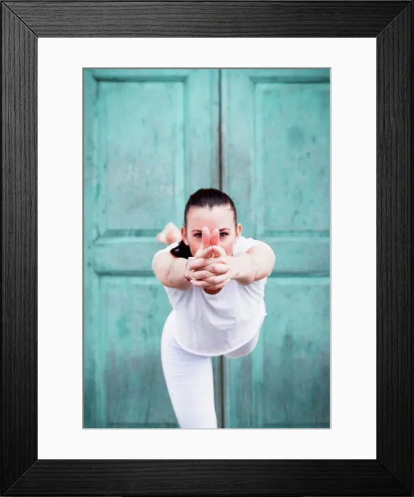 Framed Print : Woman practicing yoga, on one leg in front of door, portrait Framed Print : Woman practicing yoga, on one leg in front of door, portrait