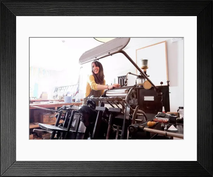 Framed Print : Woman preparing printer in shop Framed Print : Woman preparing printer in shop