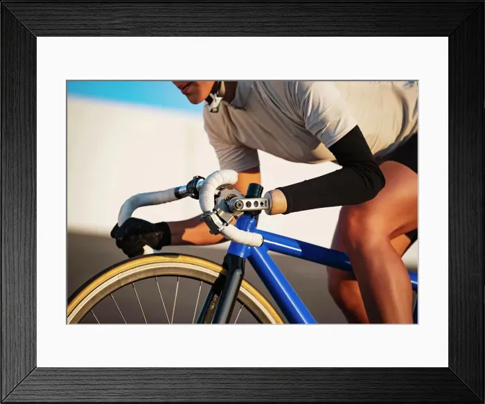 Framed Print : Close-up of athletic woman with prosthetic arm riding bicycle
