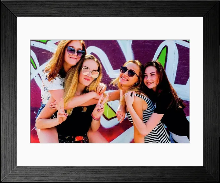 Framed Print : Girlfriends frolicking against graffiti wall