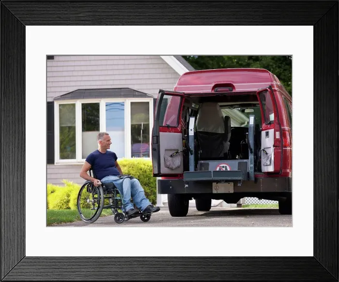 Framed Print : Man with spinal cord injury in a wheelchair getting in his accessible van Framed Print : Man with spinal cord injury in a wheelchair getting in his accessible van
