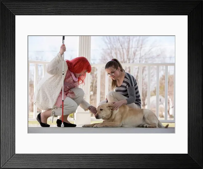 Framed Print : Two women with visual impairments, one with a service dog and one with a cane