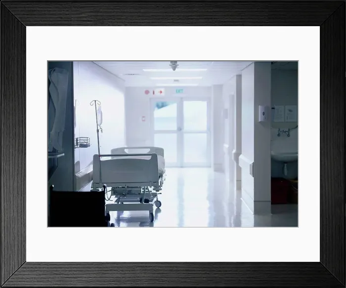 Framed Print : Empty hospital bed with intravenous drip in hospital ward